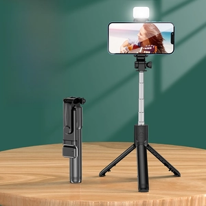 Detail showing foldable selfie stick with built-in tripod and adjustable ring light features