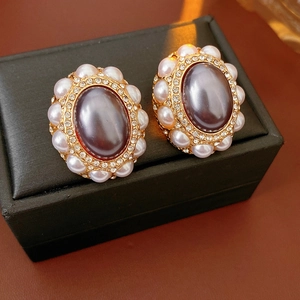 Detailed macro of vintage gold earrings with zircon crystals and small pearls decoration