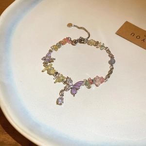 Detail of colorful stone bracelet with purple enamel butterfly and adjustable chain