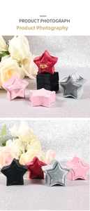 Close-up of star-shaped velvet jewelry boxes with soft texture for rings and earrings