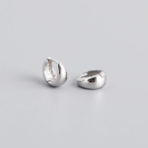 Macro view of polished S925 sterling silver hoop earrings with clear material hallmark
