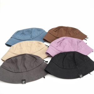 Cotton bucket hats in multiple colors with adjustable drawstrings and side labels
