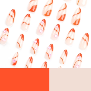 Short almond press-on nails featuring orange wave lines and small sparkling rhinestones