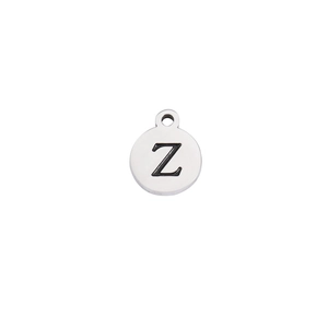 Close-up of a round silver stainless steel pendant with an engraved black letter Z