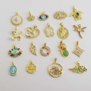 Macro shot of 18K gold plated charms with micro-inset zircons and enamel details