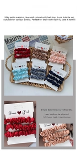 Detail showing high-quality satin scrunchies in Morandi colors on white display cards