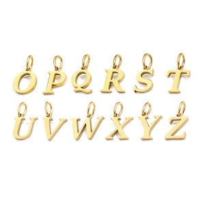 Close-up of gold-plated alphabet pendants from O to Z with a polished metallic finish