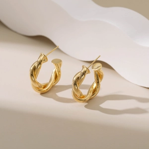 Golden C-shaped twisted rope hoop earrings with a polished metal finish for women