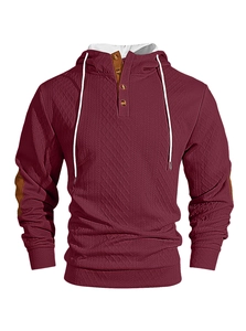 Détail du sweat à capuche bordeaux en maille gaufrée avec boutons et coudières marron