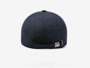 Rear view of deep blue knit baseball cap with adjustable strap and metal buckle detail