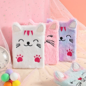 Close-up of cute plush cat notebooks with colorful fur and detailed embroidery textures