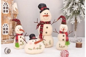 Set of four plush Christmas snowmen with red plaid scarves and hats in a snowy scene