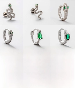 Detailed view of titanium steel snake earrings with green zircon and 0.8x6mm screw post