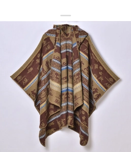 Detailed view of brown ethnic geometric pattern and woven texture on hooded cape shawl