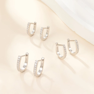 Macro shot of three S925 sterling silver U-shaped hoop earrings with zircon stones
