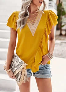 Detail of elegant yellow V-neck blouse featuring lace trim and ruffled sleeve accents