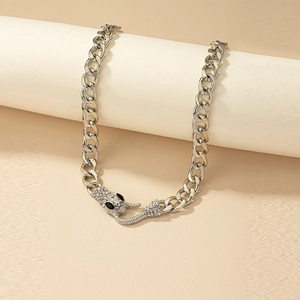 Detailed macro view of silver snake Cuban chain necklace with sparkling white rhinestones