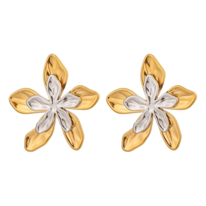 Macro shot of two-tone gold and silver flower stud earrings on a white background