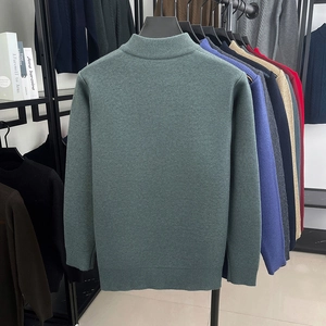 Detailed knit texture and half-zip collar on men's dark green business casual sweater