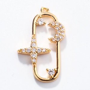 Detailed view of a gold-plated moon and star charm pendant encrusted with white crystals
