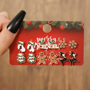 Close-up of six pairs of Christmas stud earrings including reindeer and snowflakes