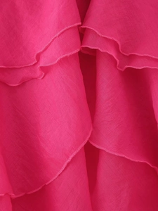 Close-up of rose pink chiffon tiered ruffles with fine edge stitching and texture