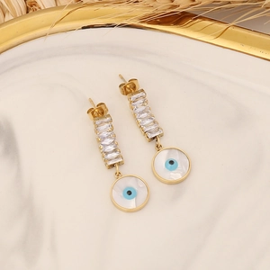Detail of gold evil eye earrings with sparkling white rectangular cubic zirconia stones