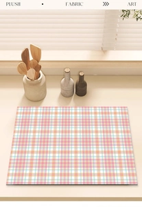 Detailed view of plush checkered drying mat with soft pink and blue plaid on a counter