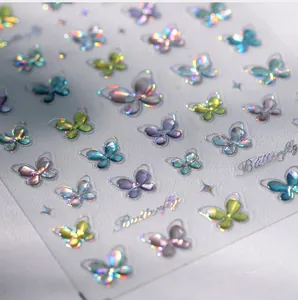 Macro detail of 3D butterfly nail art stickers with iridescent laser holographic finish