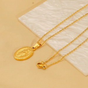 Gold-plated stainless steel Saint Jude oval religious pendant necklace on stone display