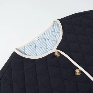 Close-up of diamond quilted jacket with contrast piping and striped cotton lining