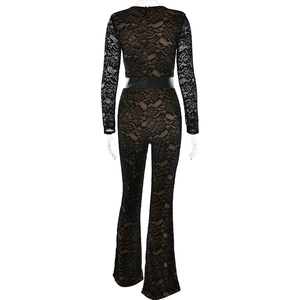 Back view of a black lace jumpsuit with beige lining, flared legs, and a black waistband