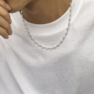 Elegante silberne Kugelkette für Damen und Herren auf einem weißen T-Shirt getragen