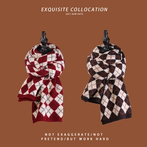 Detail of thick knitted scarves with classic diamond patterns in red, white and grey tones
