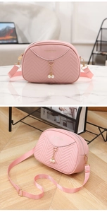 Detail of pink chevron quilted shell bag with gold hardware and pearl pendant charms