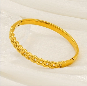 Detail of gold-plated bangle featuring a half-smooth mirror and half-chain link design