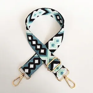 Close-up of bohemian geometric diamond pattern canvas bag strap with gold swivel hooks