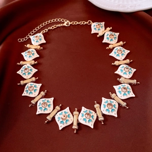 Detail of vintage enamel necklace featuring champagne gems and blue heart patterns