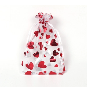White organza gift bag with red and silver foil hearts and drawstring closure