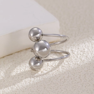 Detailed view of silver spiral ring featuring double-layer band and three polished metal beads