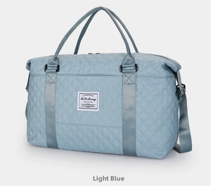 Side view of light blue quilted yoga bag with large capacity and adjustable strap
