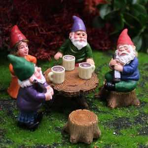 Garden dwarf figurines set with resin gnomes having a party on miniature tree stumps