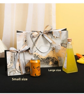 Detailed comparison of marble pattern gift bags in large and small sizes with silk handles