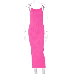 Detail of hot pink ribbed maxi dress featuring thin straps and textured wavy vertical pleats