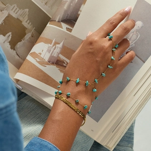 Elegant natural turquoise beaded finger bracelet with gold hammered cuff on model hands
