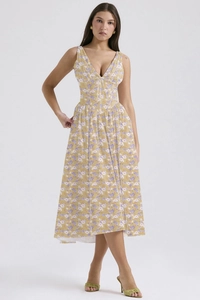 Detail of V-neck floral print dress in ginger yellow with purple blossom patterns