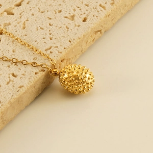 18k gold plated stainless steel necklace with textured durian fruit pendant on stone base