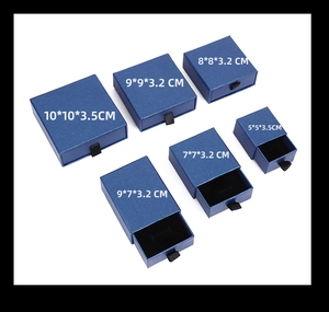 Various sizes of blue drawer jewelry boxes displayed in a professional array view