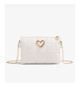 Close-up of white quilted crossbody bag with golden heart clasp and chain detail