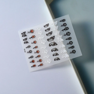 Detail of 5D embossed nail stickers featuring elegant rose and butterfly patterns